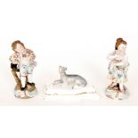 A pair of late 19th Century figurines of children, in the style of Meissen,