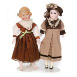 A Heubach bisque head doll with fixed brown eyes and open mouth wearing a floral brown velvet