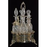A late 19th Century silver plated and clear cut glass six bottle cruet set with central oval