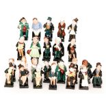 A set of twenty-four Royal Doulton Dickens figures comprising Scrooge, Micawber, Sairy Gamp,