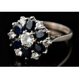 A hallmarked 18ct white gold sapphire and diamond cluster ring,
