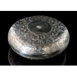 A late Victorian hallmarked silver squeeze action circular snuff box with engraved ivy leaf
