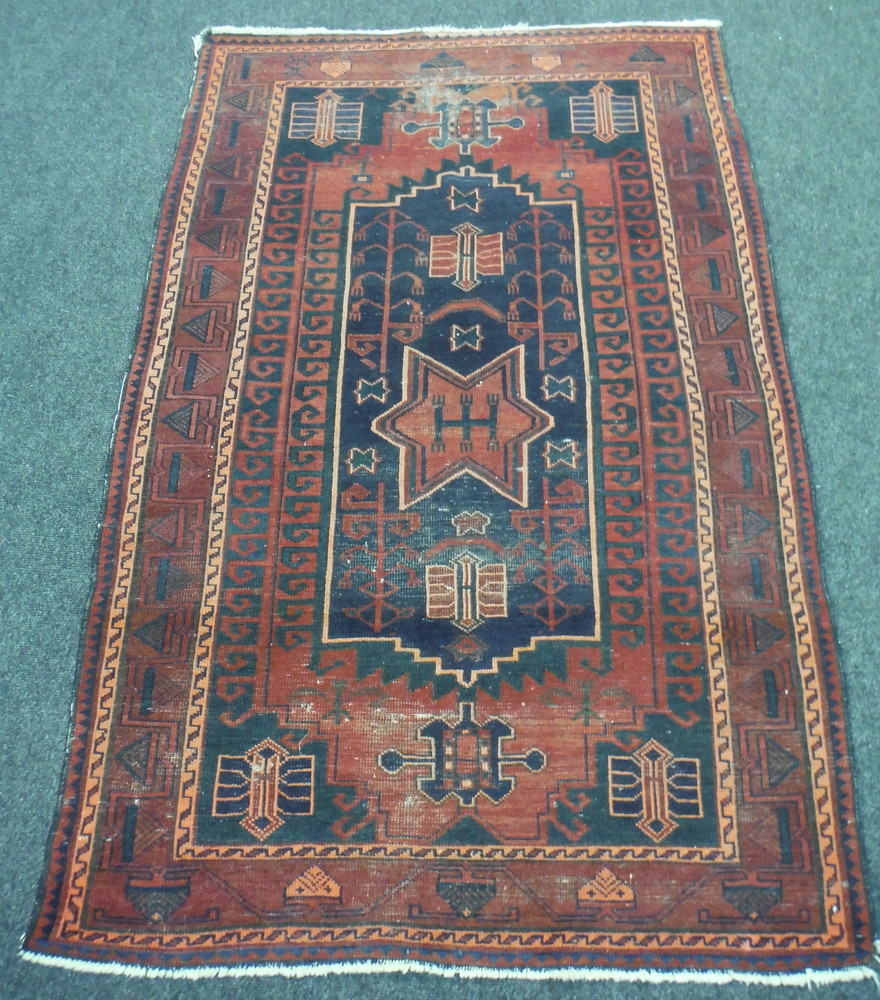 A 20th Century Middle Eastern flat woven rug, with star-shaped central medallion upon a blue field,