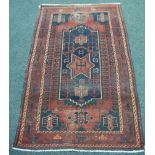 A 20th Century Middle Eastern flat woven rug, with star-shaped central medallion upon a blue field,