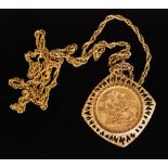 A 1958 full sovereign in a textured pierced mount suspended from a yellow metal rope chain,