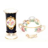 A 20th Century Meissen spill vase decorated with a hand painted floral cartouche against a blue