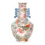 A late 19th to early 20th Century Chinese Mille Fleur twin handled vase profusely decorated with