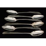 A composed set of six Irish hallmarked silver dessert spoons with bright cut feather edged