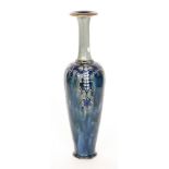 A large early 20th Century Royal Doulton vase decorated with tubelined flowers and foliage within