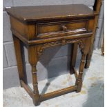 A small 17th Century style carved oak credence table fitted with a frieze drawer on turned legs