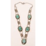 An early 20th Century Chinese silver and turquoise necklace designed with five oval pierced foliate