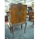 A Queen Anne style figured walnut cocktail cabinet,