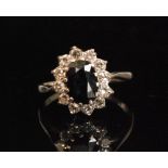 An 18ct white gold sapphire and diamond cluster ring,