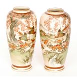 A pair of late 19th Century Japanese Satsuma vases each decorated with pheasants in flight with a