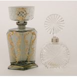 An Art Deco scent bottle of footed form to the the angular faceted body all to the stopper in the