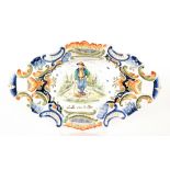 An early 20th Century French Faience oval dish decorated with a hand painted scene of a farm hand