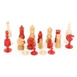 A 19th Century stained red and white bone chess set together with a similar chess set in mahogany