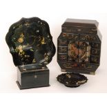 A late 19th Century Japanese lacquered table cabinet of lozenge form together with a papier mache