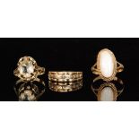 Three stone set rings to include a 9ct opal ring with forked shoulders,
