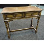 A 20th Century oak side table, fitted with two frieze drawers above a turned stretcher frame,