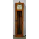 A 20th Century Gents Pul-Syn-Etic impulse clock with square white dial in beech glazed case,