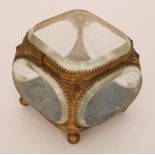 A late 19th Century gilt metal mounted bevelled glass casket of cushion form,