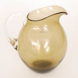 A large contemporary Simon Moore glass jug of swollen form in a deep olive with an applied handle