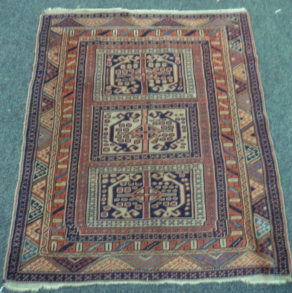 An early 20th Century Caucasian rug with three rows of guls on a rust ground, - Image 2 of 4