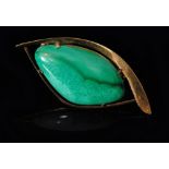 A 9ct malachite brooch centrally set with a polished asymmetric malachite cabochon within a