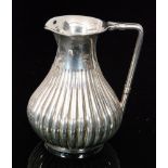 A Victorian hallmarked silver cream jug of baluster form with fluted decoration, weight 2.