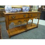 A 17th Century style light oak two drawer dresser fitted with two drawers above a shaped apron on