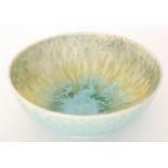 A Ruskin Pottery crystalline bowl of footed circular form decorated with a mottled blue splatter