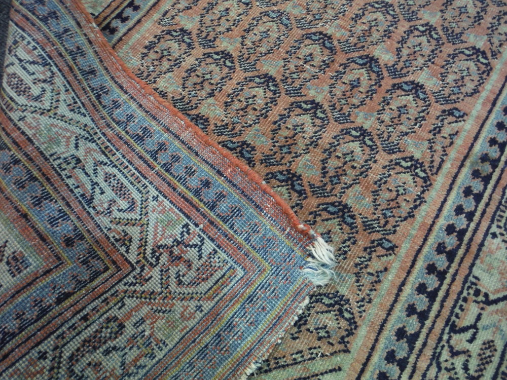 An early 20th Century Caucasian rug with three rows of guls on a rust ground, - Image 4 of 4