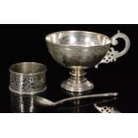 A 19th Century Russian silver pedestal cup with geometric engraved design and scrolled handle,