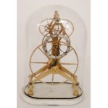 A replica brass skeleton clock with central silvered dial with an arrangement of four cog wheels in
