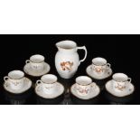 A set of six Royal Copenhagen coffee cups and saucers hand enameled with a tonal brown botanical