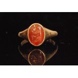 An 18ct carnelian intaglio ring depicting Hero feeding Zeus, weight 4.