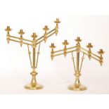 A pair of 20th Century brass five sconce altar candlesticks each with adjustable arms on circular