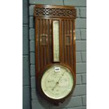 An Arts and Crafts style mahogany aneroid barometer by Thompson Edinburgh,