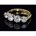 An 18ct four stone diamond ring, composed of two round brilliant cut diamonds each approximately 0.