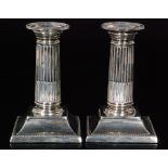 A pair of hallmarked silver Corinthian column piano candlesticks,