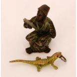 A 19th Century miniature cold painted bronze figure of a Moorish figure wearing a fez,