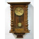 A late 19th Century Vienna walnut cased spring driven wall clock,