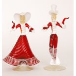 A pair of post war Italian Murano glass figures of a dandy and his lady in stylised ruby costume