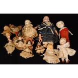 A collection of ten Victorian and later small dolls to include moulded head examples and a