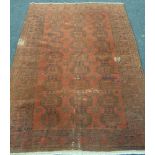 An early 20th Century Middle Eastern flat woven maroon rug, with repeat pattern, 227cm x 166cm, A/F.