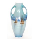 An early 20th Century Shelley twin handled vase decorated with a hand tinted scene of two sailing