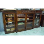 An Edwardian carved mahogany breakfront floorstanding bookcase with fitted adjustable shelves