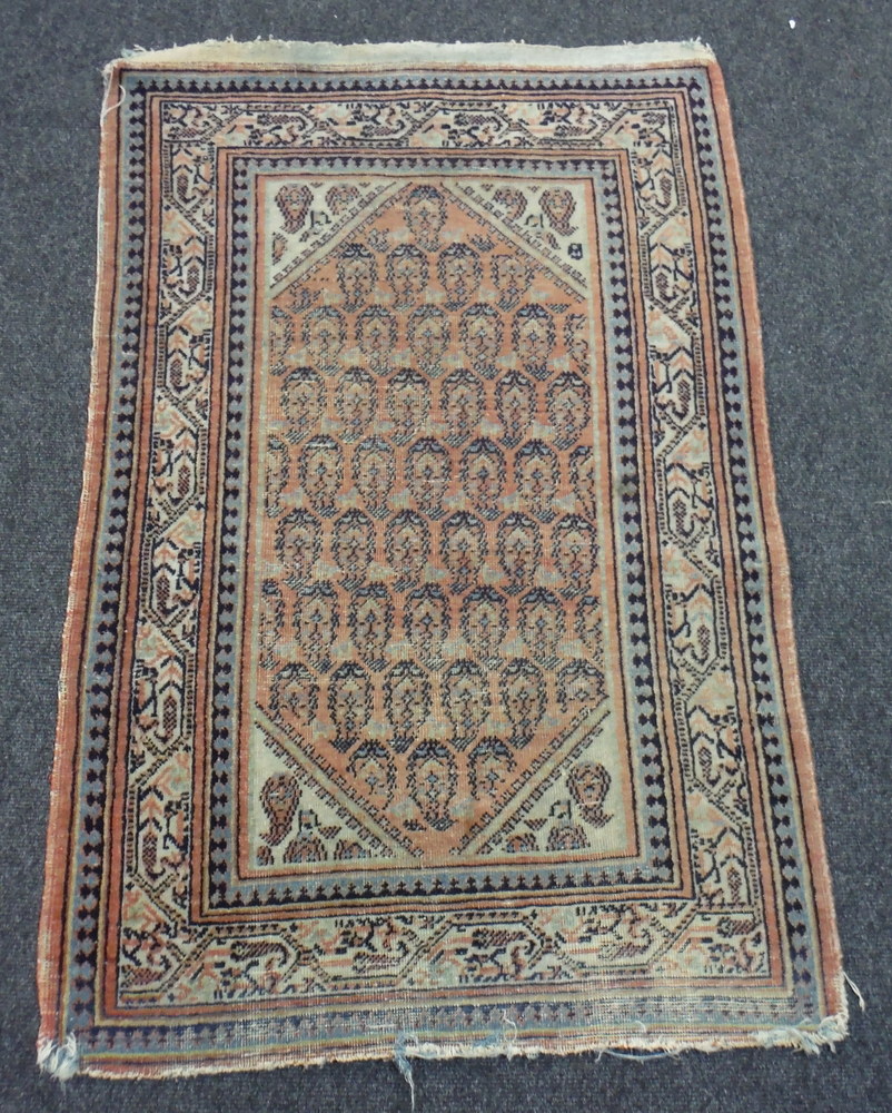 An early 20th Century Caucasian rug with three rows of guls on a rust ground, - Image 3 of 4
