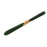 A 19th Century spinach jade page turner or letter opener mounted with silver gilt coronet central